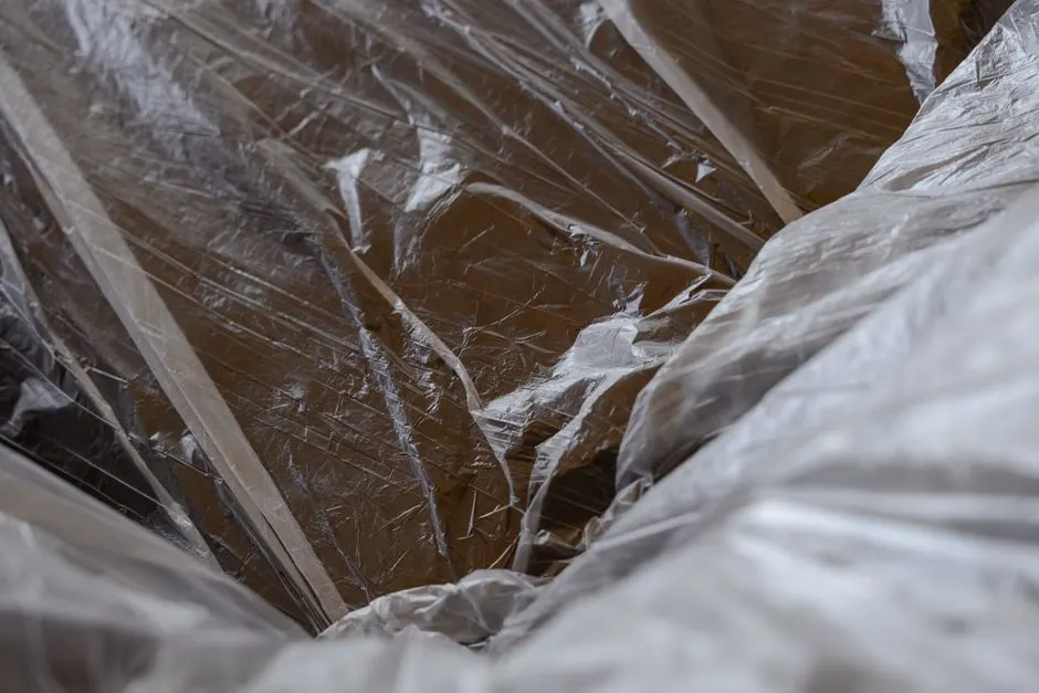 Close-up of transparent plastic sheeting over a wooden surface, revealing textures.